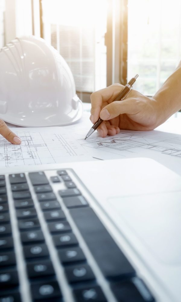 Image of engineer meeting for architectural project. working with partner and engineering tools on workplace vintage tone.