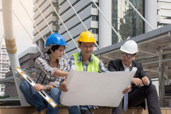 team-engineers-foreman-working-outdoorsdiscussing-with-project-plans